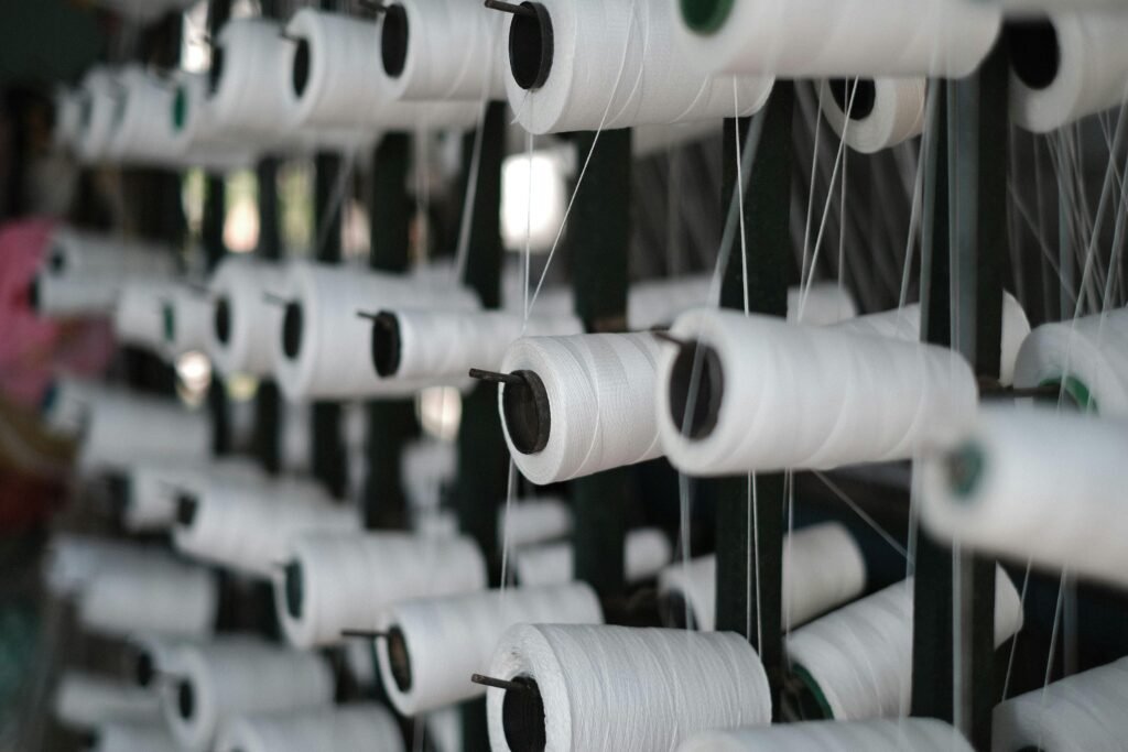 Textile yarn cones in a production machine used for chenille yarn sourcing